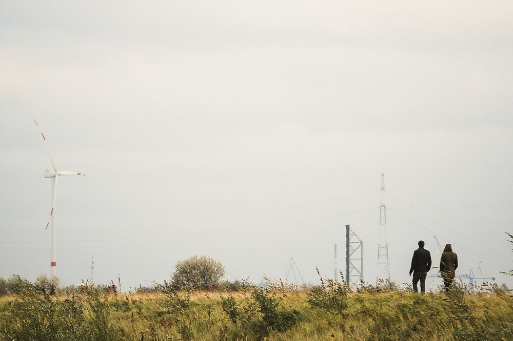 Two people walking through a field